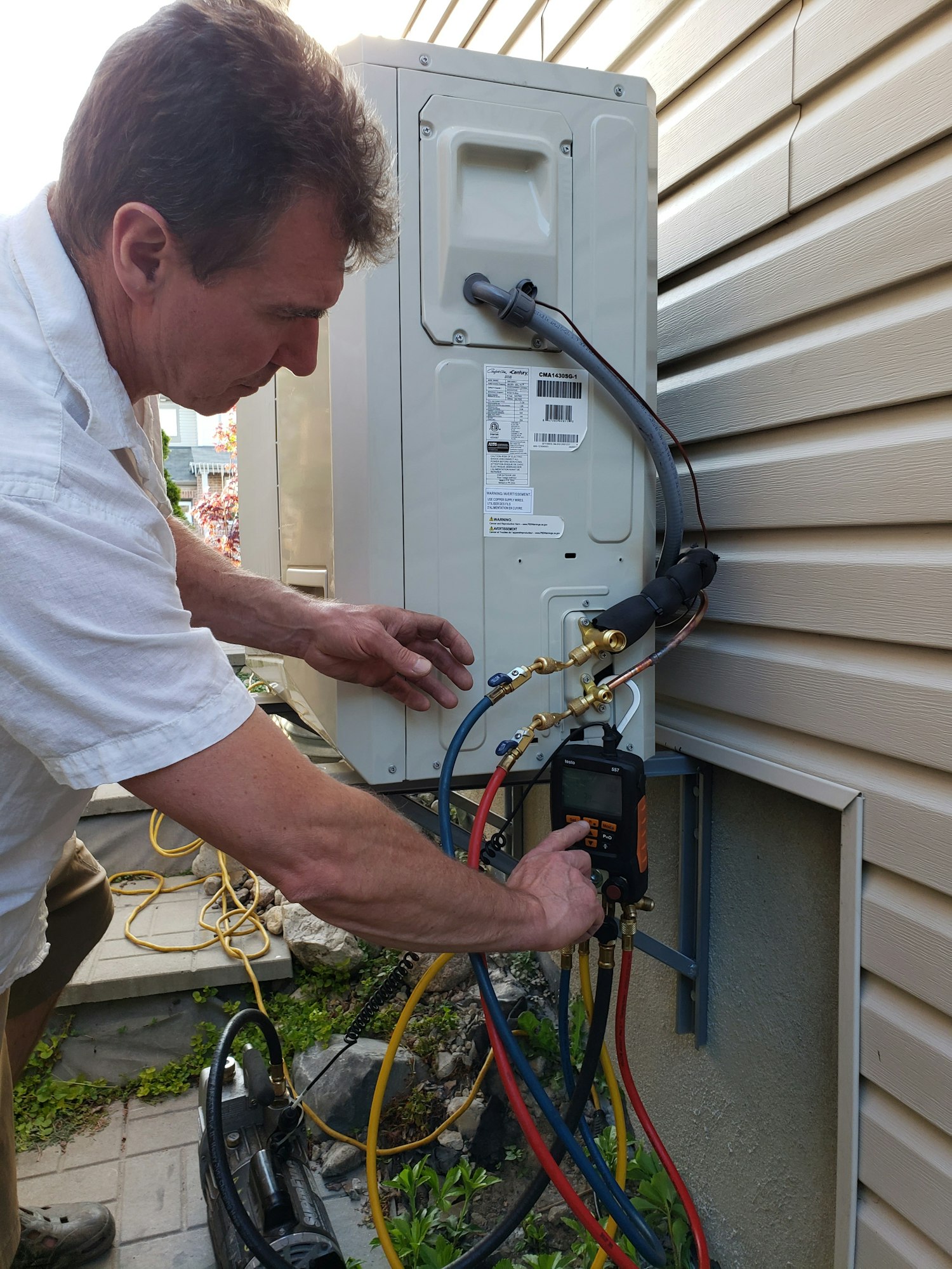 Man is checking proper functionality of electric equipment by measuring electrical current