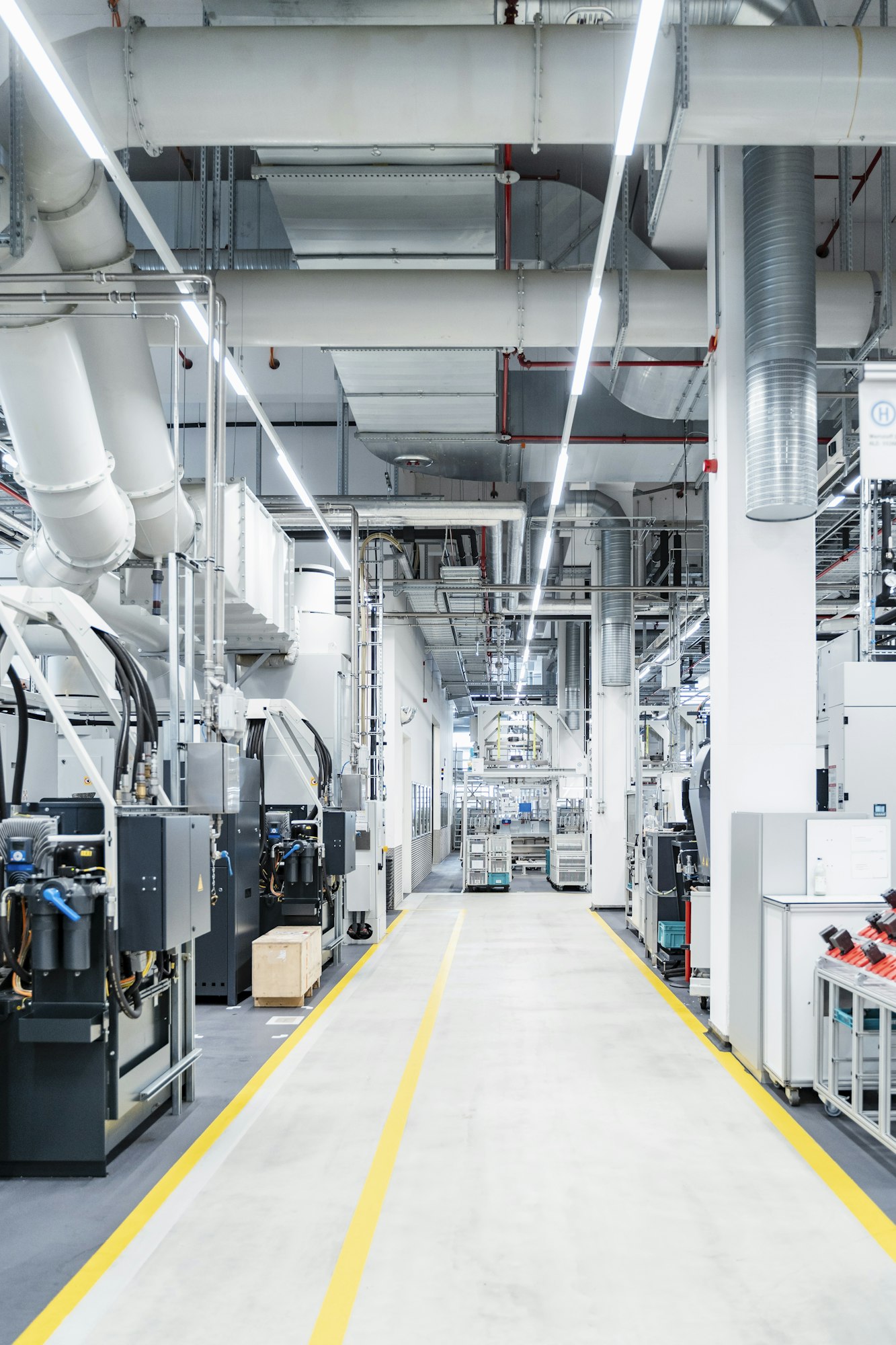 Pipes and air duct over footpath in modern factory, Stuttgart, Germany